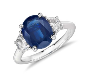 Blue Nile Oval Sapphire and Diamond Ring in Platinum (10x8mm) Distinctly glamorous, this sapphire and diamond ring showcases a deep blue, oval sapphire with two half-moon diamond side stones. This platinum three-stone ring is a beautiful diamond engagement ring option.