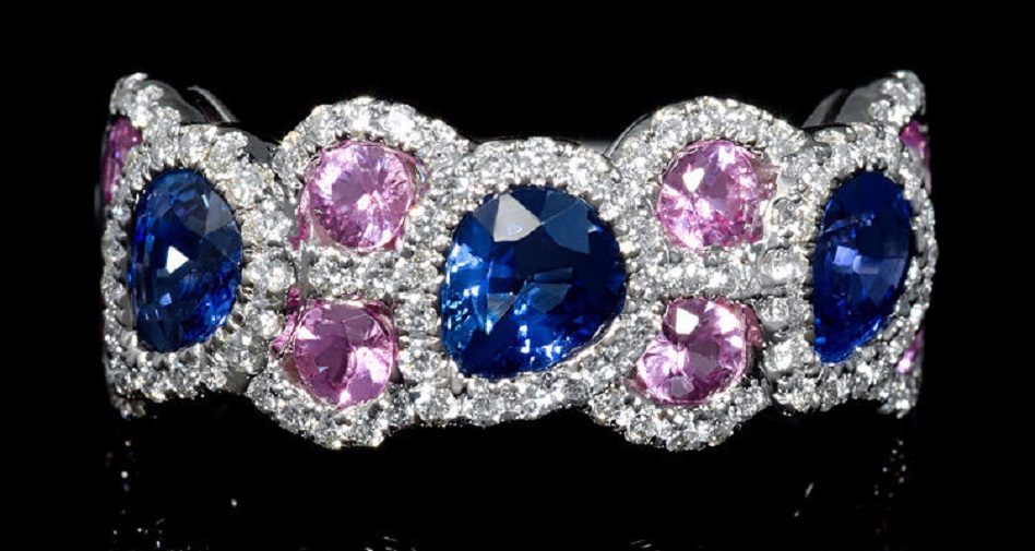 18k White Gold Diamond and Sapphire Ring This elegant 18k white gold ring, features 110 round brilliant cut white diamonds of F color, VS2 clarity, of excellent cut and brilliance, weighing .46 carat total, with 8 pink sapphires, of exquisite color, weighing .73 carat total and 3 pear cut blue sapphires, of exquisite color, weighing 1.28 carats total.